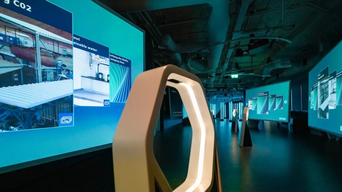 Siemens Experience Centre gallery with projected walls and a lit hexagonal display stand in the foreground